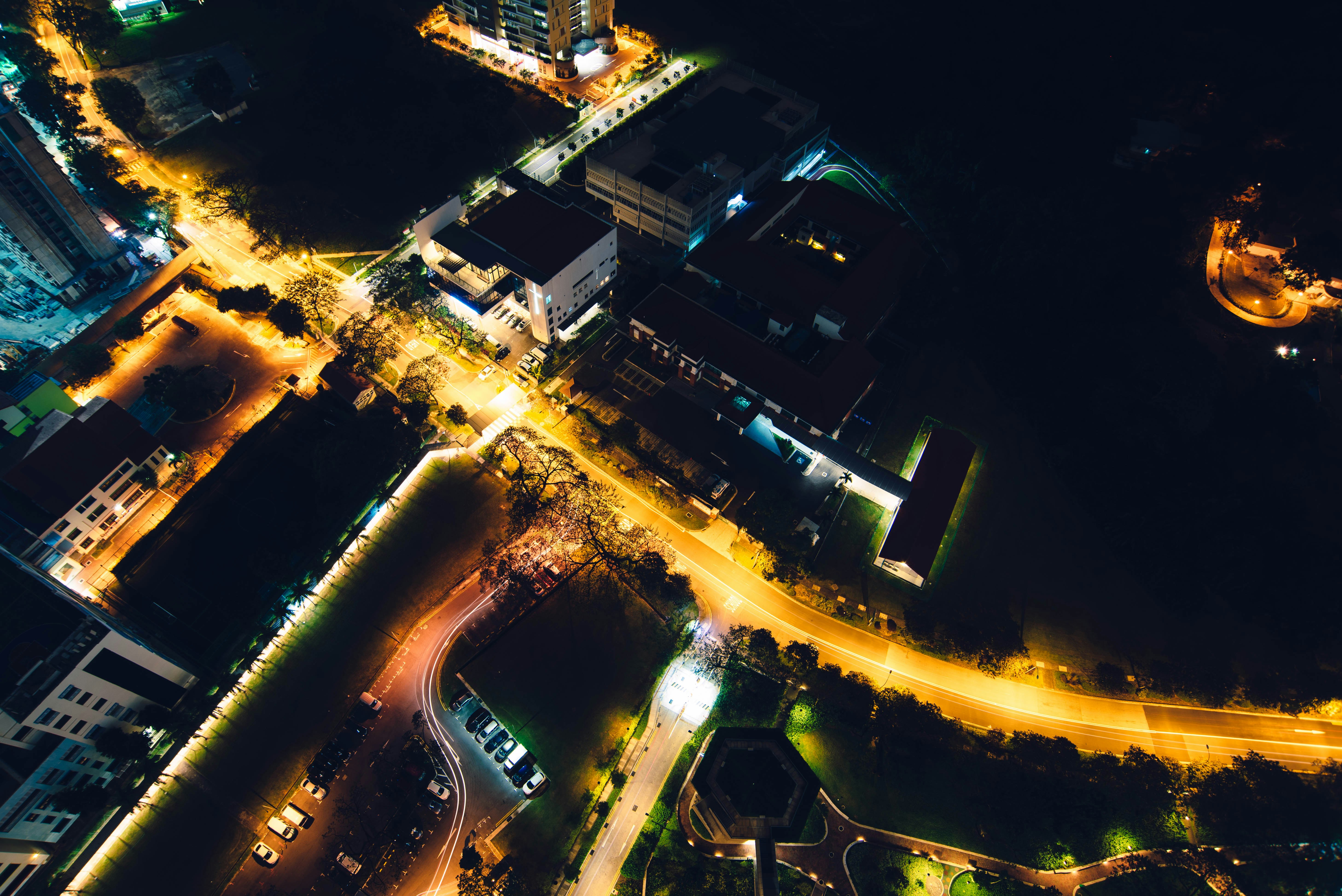 time-lapse photography of asphalt road between city buildings